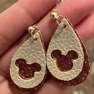 Pink dangly Disney earrings with glitter.